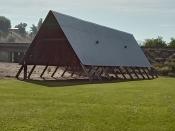 A large shelter longhouse in a park setting